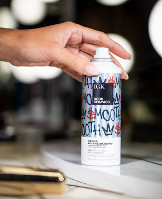 a person holding a spray can