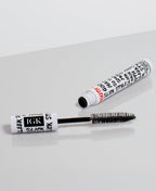 XL Taming Wand with black brush and white cylindrical container on a light gray background
