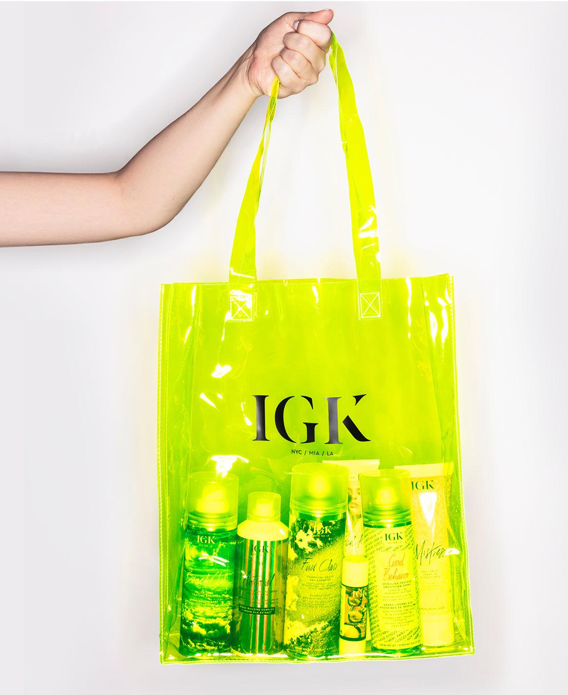 a hand holding a yellow bag with bottles in it